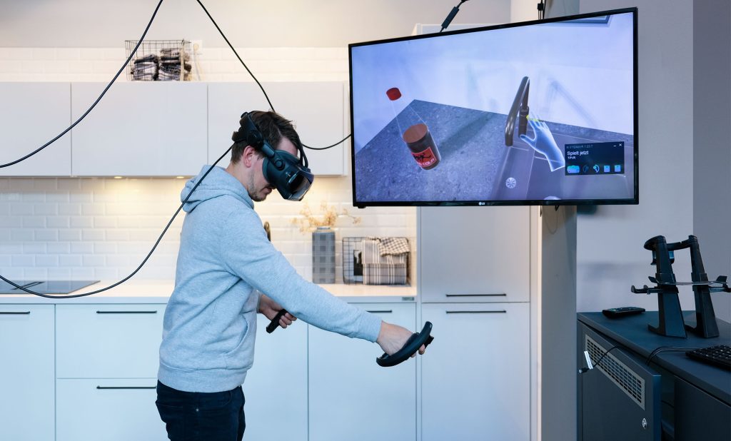 Mann mit VR-Brille Küche in 3D Bildschirm